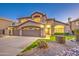 Charming two-story home with a well-manicured front yard landscape with shrubs at 1349 E Rock Wren Rd, Phoenix, AZ 85048