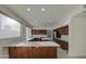 Modern kitchen with wood cabinets, quartz countertops and stainless steel appliances at 1349 E Rock Wren Rd, Phoenix, AZ 85048
