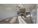 Spacious living room with stone fireplace, ceiling fan, wood-look tile floors, and big windows at 1349 E Rock Wren Rd, Phoenix, AZ 85048