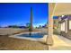 Backyard view of a private pool with concrete patio, lush vegetation, and privacy fence in the distance at 1349 E Rock Wren Rd, Phoenix, AZ 85048