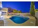 Backyard private pool with an elevated spa and desert mountain views at dusk at 1349 E Rock Wren Rd, Phoenix, AZ 85048