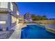 Backyard with private swimming pool and a desert mountain view at dusk at 1349 E Rock Wren Rd, Phoenix, AZ 85048