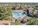 A beautiful aerial view of the community pool, clubhouse, and tennis courts at 1351 N Pleasant Dr # 1031, Chandler, AZ 85225