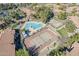 Aerial view of community pool, hot tub, and tennis courts surrounded by lush landscaping at 1351 N Pleasant Dr # 1031, Chandler, AZ 85225
