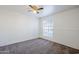 Bedroom with ceiling fan, neutral carpet, wainscotting and window offering natural light at 1351 N Pleasant Dr # 1031, Chandler, AZ 85225