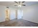 Bedroom with ceiling fan, neutral carpet, wainscotting, and access to the other rooms at 1351 N Pleasant Dr # 1031, Chandler, AZ 85225