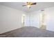 Bedroom with ceiling fan, neutral carpet, wainscotting, and access to the other rooms at 1351 N Pleasant Dr # 1031, Chandler, AZ 85225