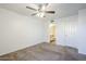 Bedroom with ceiling fan, neutral carpet, wainscotting and access to the bathroom at 1351 N Pleasant Dr # 1031, Chandler, AZ 85225