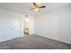 Bedroom with ceiling fan, neutral carpet, wainscotting, and access to the bathroom at 1351 N Pleasant Dr # 1031, Chandler, AZ 85225