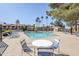 Relaxing community pool area with ample seating and views of lush tropical landscaping at 1351 N Pleasant Dr # 1031, Chandler, AZ 85225
