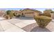 Wide driveway leading to a two car garage door of a single story home with desert landscaping at 1357 E Loma Vista St, Gilbert, AZ 85295