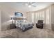 Serene bedroom with large windows, ceiling fan, and neutral tones at 14917 W Yosemite Dr, Sun City West, AZ 85375