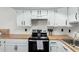 Bright kitchen features white cabinets, butcher block countertops, and modern appliances at 2040 S Longmore -- # 5, Mesa, AZ 85202