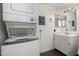 The laundry room features a stacked washer and dryer next to the single sink and vanity at 2040 S Longmore -- # 5, Mesa, AZ 85202