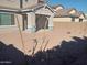 Gravel backyard featuring a newly planted tree, block wall, and covered patio at 20941 E Via Del Sol St, Queen Creek, AZ 85142
