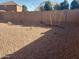 Gravel backyard featuring a newly planted tree and block wall at 20941 E Via Del Sol St, Queen Creek, AZ 85142
