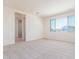 Bright bedroom with large window, neutral carpet, and ensuite bathroom for modern living at 20941 E Via Del Sol St, Queen Creek, AZ 85142
