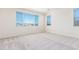Bright bedroom with large windows and neutral carpet, offering a serene atmosphere at 20941 E Via Del Sol St, Queen Creek, AZ 85142