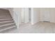 Bright entryway with tile floors, a staircase, and a modern white color scheme at 20941 E Via Del Sol St, Queen Creek, AZ 85142