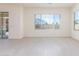 Bright living room featuring light floors, large windows, and ample natural light at 20941 E Via Del Sol St, Queen Creek, AZ 85142