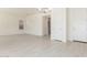 Spacious living area showcasing white floors, modern lighting, and multiple entryways at 20941 E Via Del Sol St, Queen Creek, AZ 85142
