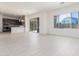 Spacious living area blends seamlessly with the kitchen, showcasing sleek tile flooring and natural light at 20941 E Via Del Sol St, Queen Creek, AZ 85142