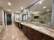 Elegant bathroom with dual sinks, granite countertops, and a view of the luxurious shower and tub at 2211 E Camelback Rd # 306, Phoenix, AZ 85016