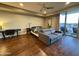 Bright bedroom with ceiling fan, desk, and outside patio access through sliding glass doors at 2211 E Camelback Rd # 306, Phoenix, AZ 85016