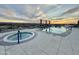 Modern rooftop pool and spa with comfortable lounge seating and a picturesque sunset backdrop at 2211 E Camelback Rd # 306, Phoenix, AZ 85016