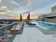 Relaxing rooftop pool area featuring comfortable lounge chairs and a stunning city view at sunset at 2211 E Camelback Rd # 306, Phoenix, AZ 85016