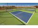 Well-maintained pickleball courts with blue playing surfaces and net in a fenced outdoor sports area at 24385 N 173Rd Ln, Surprise, AZ 85387