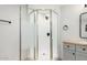 Beautiful shower with a modern glass door and a stylish grey vanity at 2904 W Coolidge St, Phoenix, AZ 85017