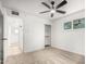 Bedroom with carpet, ceiling fan, white walls, a closet, and access to the bathroom at 2904 W Coolidge St, Phoenix, AZ 85017