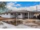 Charming exterior of this newly renovated home featuring a covered parking area and spacious front yard at 2904 W Coolidge St, Phoenix, AZ 85017