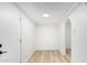 Hallway with pristine white walls, modern flooring, and an arched doorway, illuminated by a ceiling light at 2904 W Coolidge St, Phoenix, AZ 85017