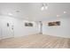 Bright and spacious living room with modern light fixture and new light floors at 2904 W Coolidge St, Phoenix, AZ 85017