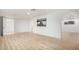 Spacious living room with white walls, wood floors, and an archway leading to another room at 2904 W Coolidge St, Phoenix, AZ 85017