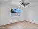 Clean bedroom with a ceiling fan, tile floors, and a window overlooking the backyard at 2958 E Contessa St, Mesa, AZ 85213
