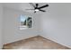 Bright bedroom featuring tile flooring, ceiling fan, and a large window at 2958 E Contessa St, Mesa, AZ 85213