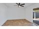 Neutral-colored bedroom with tile floors, a ceiling fan, and sliding glass door to the backyard at 2958 E Contessa St, Mesa, AZ 85213