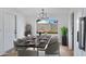 Formal dining room with modern chandelier and view to backyard at 2958 E Contessa St, Mesa, AZ 85213