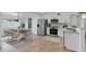 Bright kitchen with stainless steel appliances, white cabinetry and adjacent dining area at 2958 E Contessa St, Mesa, AZ 85213