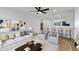 Open living room with a sofa, chairs, and barstool seating at the counter at 2958 E Contessa St, Mesa, AZ 85213