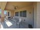 The covered patio features neutral stucco walls and a ceiling fan at 29903 N 127Th Ave, Peoria, AZ 85383