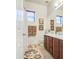 Bathroom featuring a double sink vanity, floral rug, and neutral-colored walls at 3010 E Cedar Dr, Chandler, AZ 85249