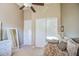 Neutral bedroom featuring a ceiling fan, closet, and a daybed with decorative pillows at 3010 E Cedar Dr, Chandler, AZ 85249