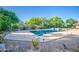 Gorgeous pool surrounded by mature trees, featuring rock landscaping, lights and a spacious deck for entertaining at 3010 E Cedar Dr, Chandler, AZ 85249