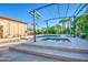 Stunning backyard with a luxurious pool, elevated spa, and a covered seating area with string lights at 3010 E Cedar Dr, Chandler, AZ 85249