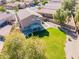 A large home with a spacious, manicured backyard featuring a covered patio and established landscaping at 30263 N Bobcat Way, San Tan Valley, AZ 85143