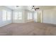 Bonus room showcasing neutral carpet, a ceiling fan, and three large windows at 30263 N Bobcat Way, San Tan Valley, AZ 85143